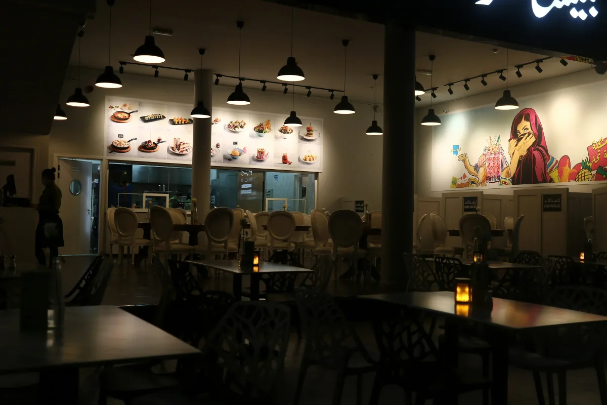 Restaurant terrace with tables under string lights at Global Village Dubai